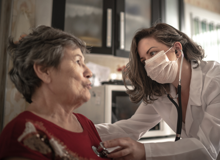 Medical professional wearing masks with patient